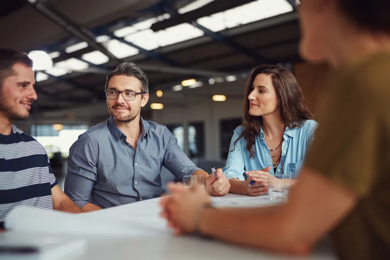 Professionals discussing a business plan around a table